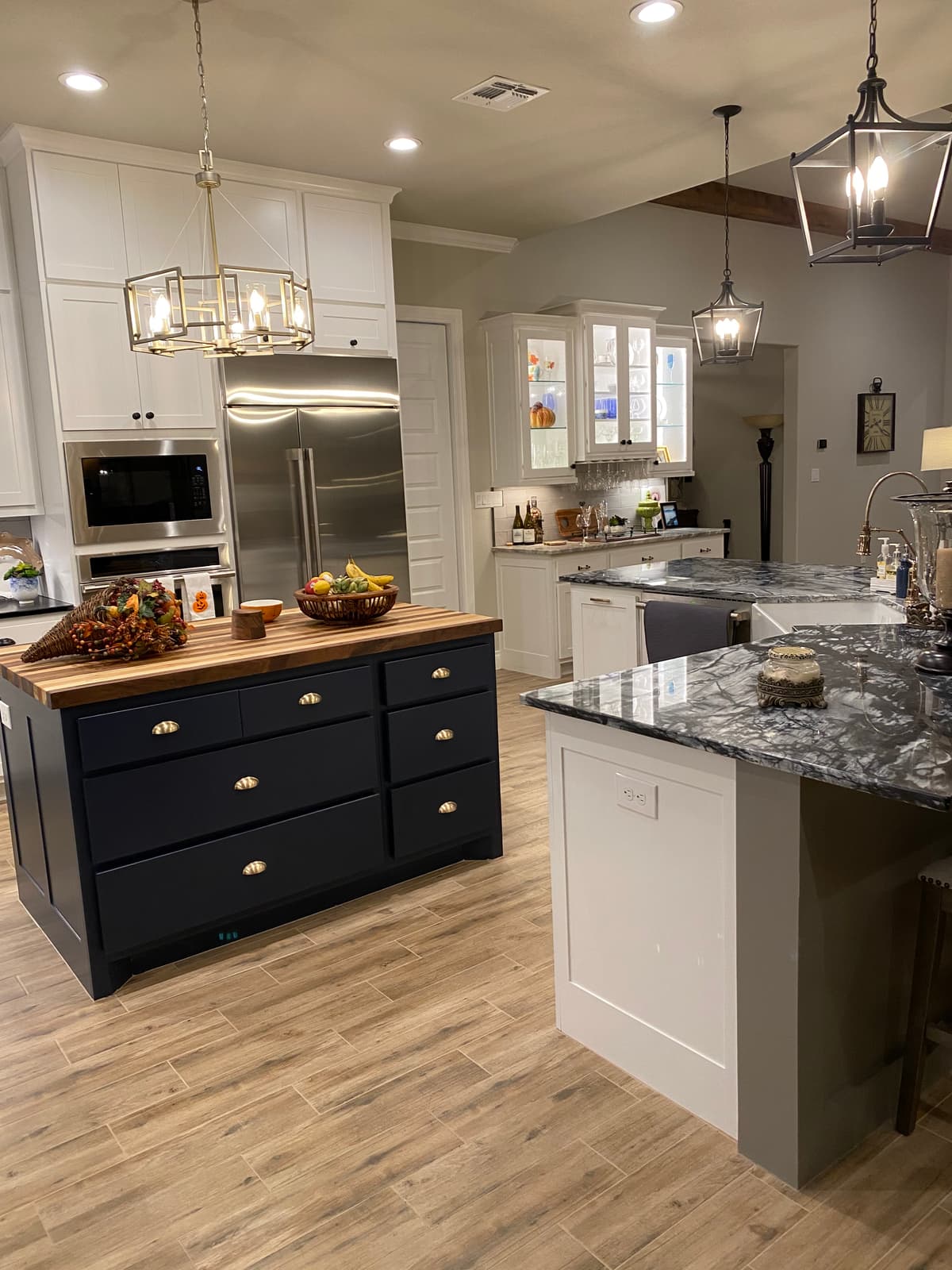 Detail of custom navy cabinetry styling with fresh florals and layered decor in a Dallas Fort Worth custom home